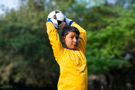 Portrait Of A Young Boy  throwing footballの写真素材
