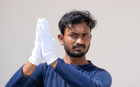 A goalkeeper pointing a soccer ball