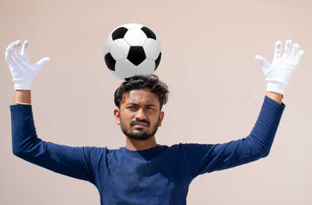 Footballer balancing soccer ball on his headの写真素材