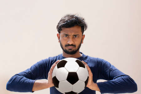 Indian Footballer Holding soccer ball