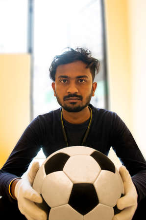 Portrait of Indian Footballer Holding soccer ball