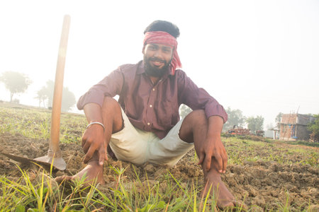 Indian Young Rural Farmer  Sitting in agricultural fieldの写真素材