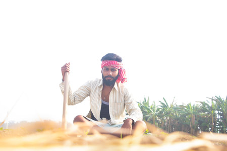 Indian Young Farmer Sitting on his agriculture fieldの写真素材