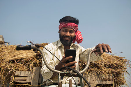 Young Adult man driving machine rickshaw and using smartphoneの写真素材