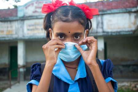 indian Rural School Girl wearing  mask Standing in schoolの写真素材