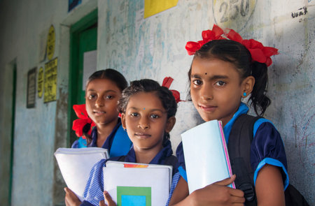Indian Rural School Girls Holding Books Standing in Schoolの写真素材