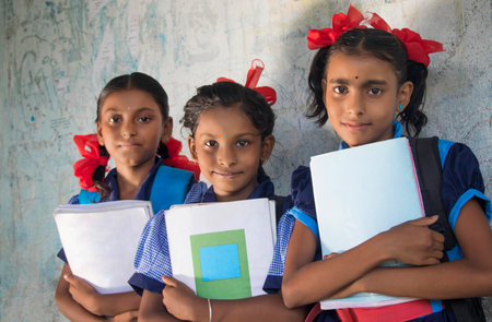 Indian Rural School Girls Holding Books Standing in Schoolの写真素材