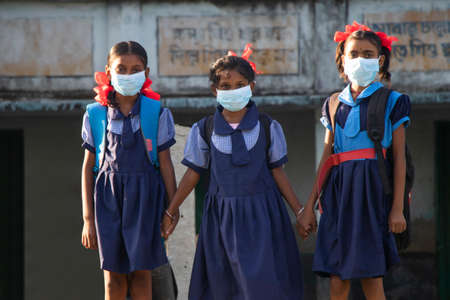 indian village government school girls Wearing mask standing at schoolの写真素材