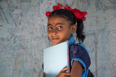 Indian Rural School Girl Holding Books Standing in Schoolの写真素材