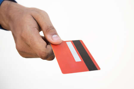 A human hand holding a credit cardの写真素材