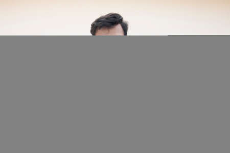 young man clenching fist in excitement and cheeringの写真素材