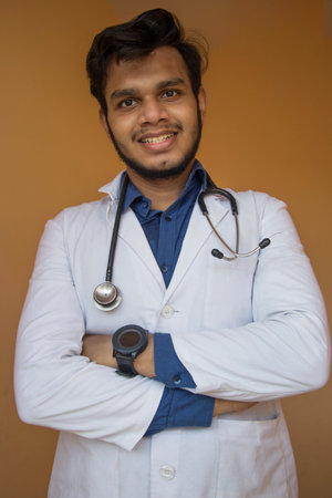 Male doctor  smile with stethoscope folded crossed handsの写真素材