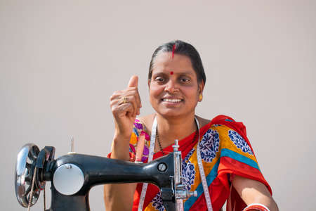 Rural woman Worker Tailor showing Thumbs Upの写真素材