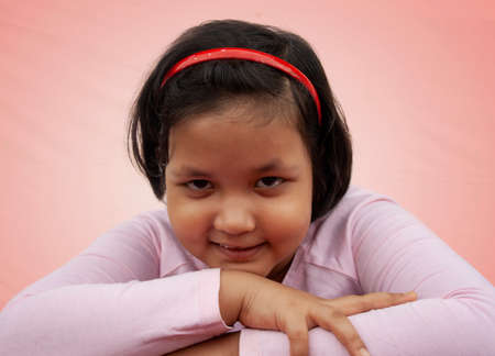 Portrait of girl smiling on color backgroundの写真素材