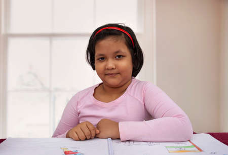 Young girl doing home workの写真素材