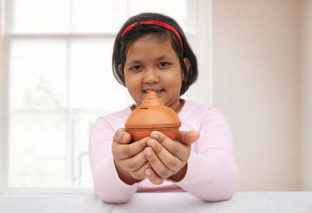Young girl holding a piggy bankの写真素材