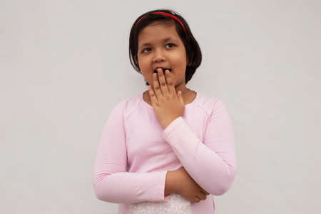Surprised Indian girl covering mouthの写真素材