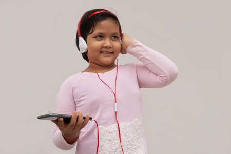Girl  with headphone while listing to music on smartphoneの写真素材
