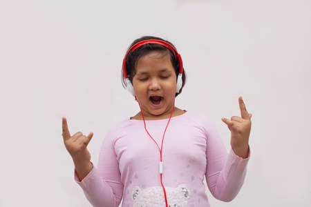 Girl with headphone dancing while listing to music on smartphoneの写真素材