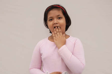 Surprised Indian girl covering mouthの写真素材