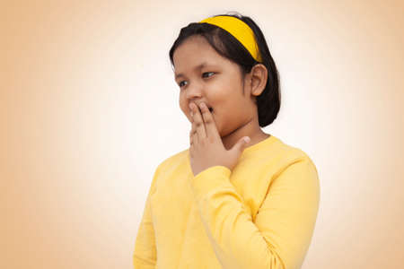 Surprised Indian girl covering mouthの写真素材