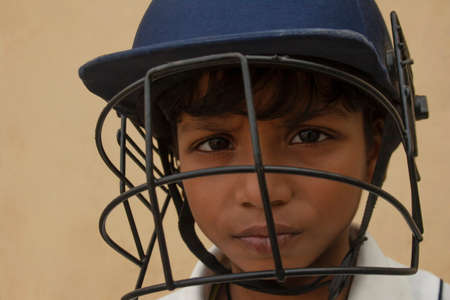 Portrait of boy wearing cricket Helmetの写真素材