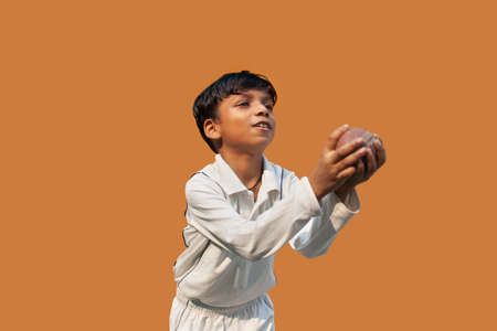 Boy catching cricket ballの写真素材