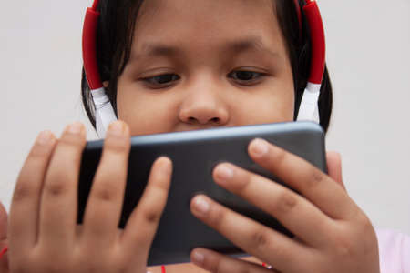 Girl Listening Music While Using Smart Phoneの写真素材