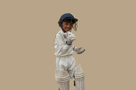 Boy in cricket uniform A victorious standing in frontの写真素材