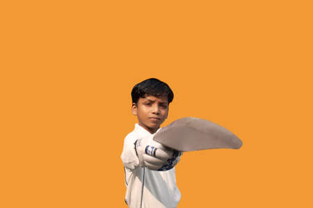 Portrait of boy celebrating his success in cricketの写真素材
