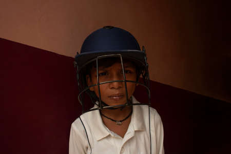 Portrait of boy wearing cricket helmetの写真素材