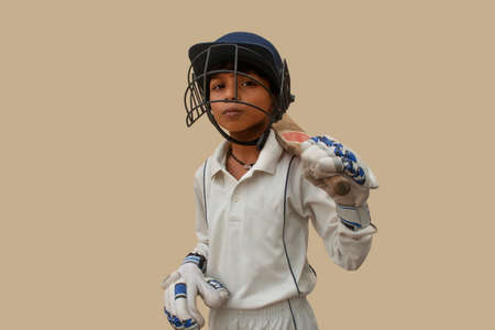 Confident boy wearing cricket helmet and ready for playingの写真素材