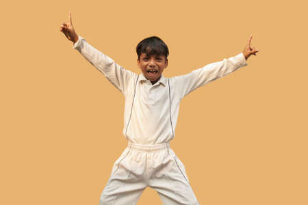 A boy celebration taking a catch During a Cricket Game