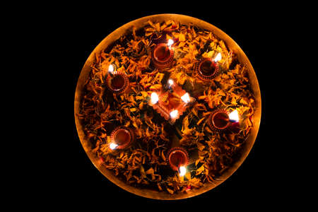 High Angle View Of Lit Diyas In Plate On Floorの写真素材