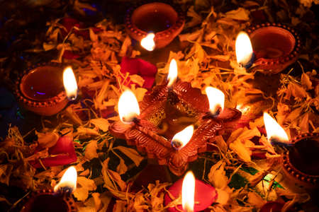 Group of diyas in flower petals during Diwaliの写真素材
