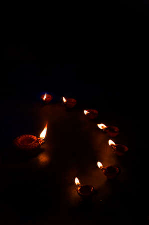 Group of decorated diyas on black background during Diwaliの写真素材