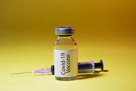 Coronavirus Covid-19 vaccine with syringe isolated on Dark backgroundの写真素材