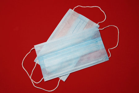 Surgical mask on Red backgroundの写真素材