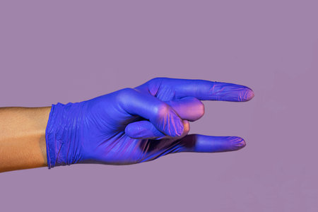 Hand In Medical Glove Showing Thumb Up On Grey Background