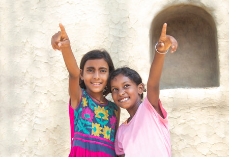 Young rural girl pointing towards up