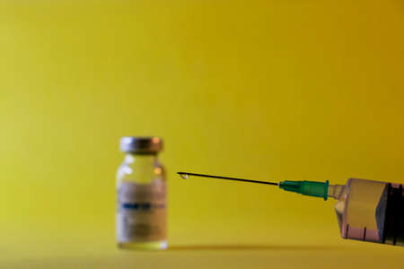 Close-Up Of Syringe On Yellow Backgroundの写真素材