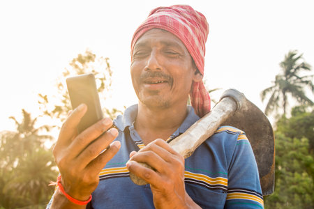 Rural Indian Man Holding mobile phoneの写真素材