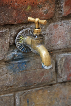 Old bronze water tapの写真素材