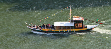 OPORTO, PORTUGAL - OCT 29, 2013  Ancient town in Portugal  Old boat convey the excursions a tourist on the Douro river  October 29, 2013 のeditorial素材