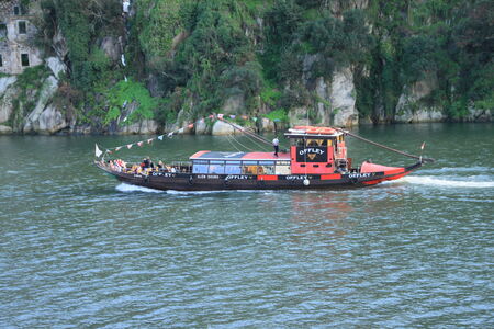 OPORTO, PORTUGAL - OCT 29, 2013  Ancient town in Portugal  Old boat convey the excursions a tourist on the Douro river  October 29, 2013  のeditorial素材