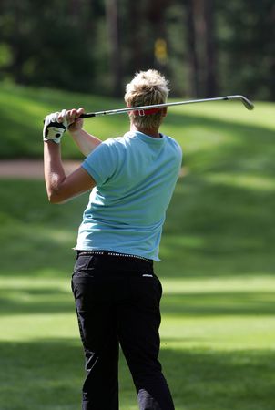 Golfer strikes a tee shotの写真素材