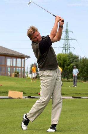 Golf player strikes a shotの写真素材