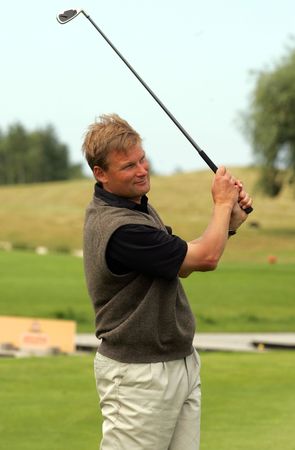 Golfer strikes a shotの写真素材