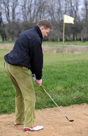 Golfer strikes a shotの写真素材