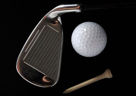 Golf club, ball and tee in the black background